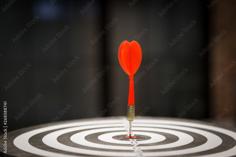 Red dart target arrow hitting on bullseye with,Target marketing and business success concept - Image Red dart target arrow hitting on bullseye with,Target marketing and business success concept - Image
