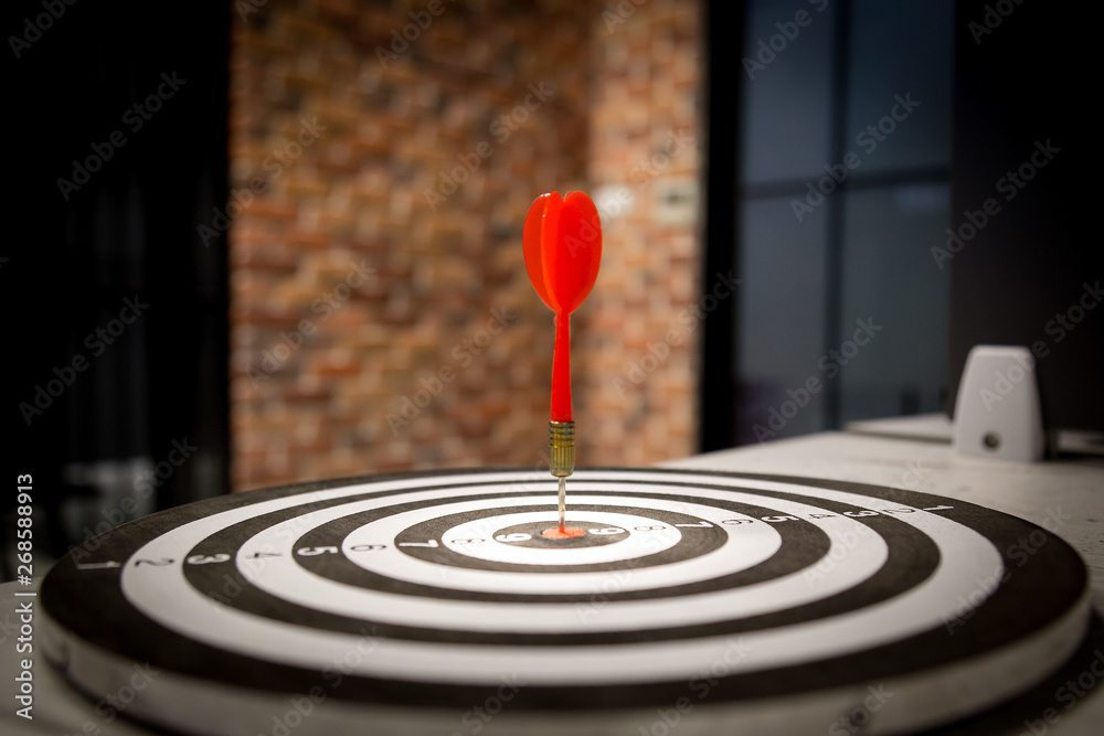 Red dart target arrow hitting on bullseye with,Target marketing and business success concept - Image Red dart target arrow hitting on bullseye with,Target marketing and business success concept - Image