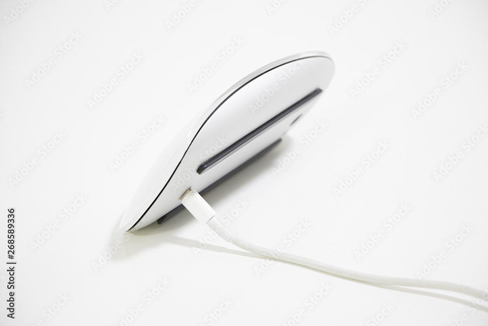 Charging a wireless mouse with a charging cable from a home power outlet Charging a wireless mouse with a charging cable from a home power outlet
