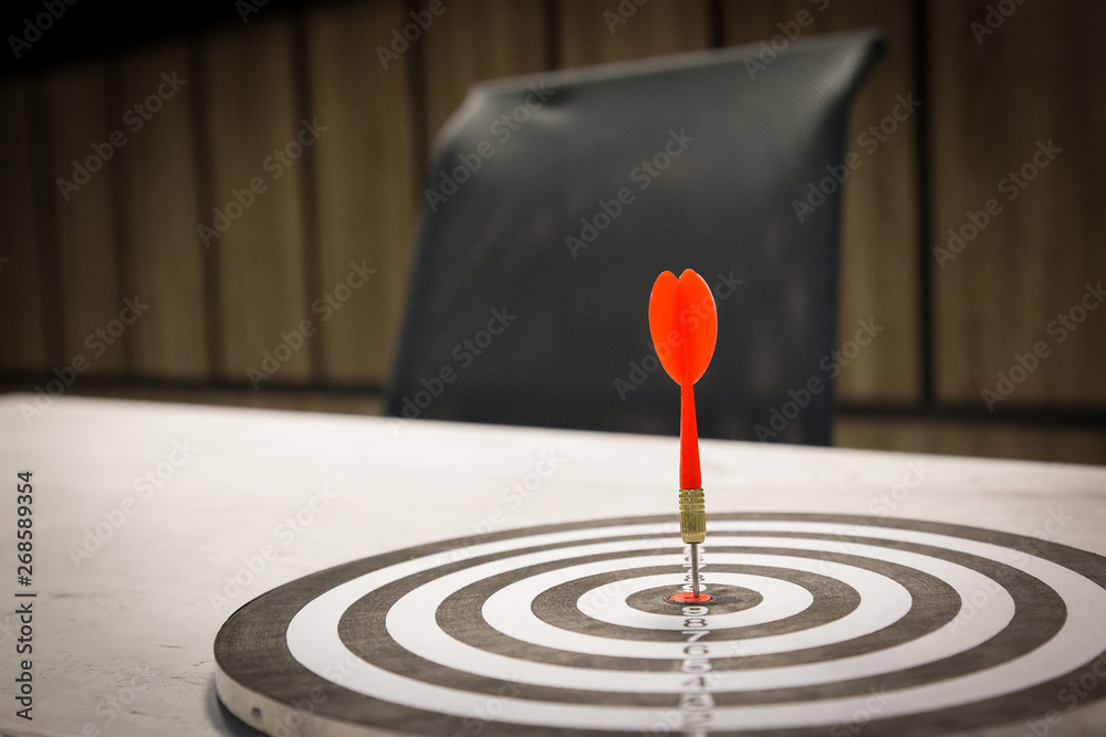 Red dart arrow hitting in the target center of dartboard on bullseye with sun light vintage style, Target marketing and business success concept - Image. Red dart arrow hitting in the target center of dartboard on bullseye with sun light vintage style, Target marketing and business success concept - Image.