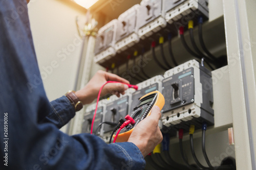 Wallpaper Mural Electrician engineer work  tester measuring  voltage and current of power electric line in electical cabinet control. Torontodigital.ca