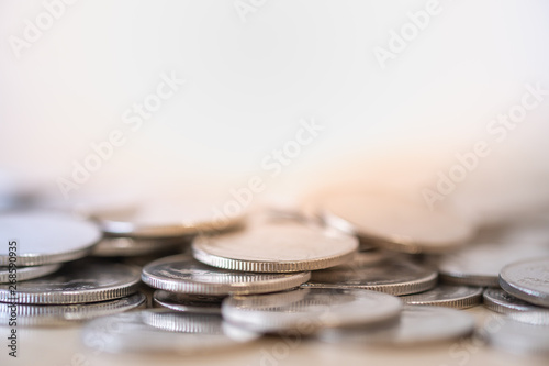 Money na dBusiness Concept. Close up of pile of silver coins on wooden table with copy space for text. photo