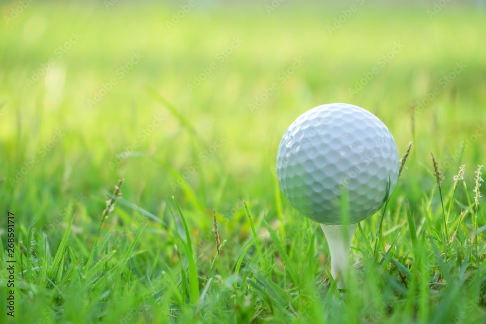 Golf ball on tee in beautiful golf course at sunset background. Golf ball on tee in beautiful golf course at sunset background.