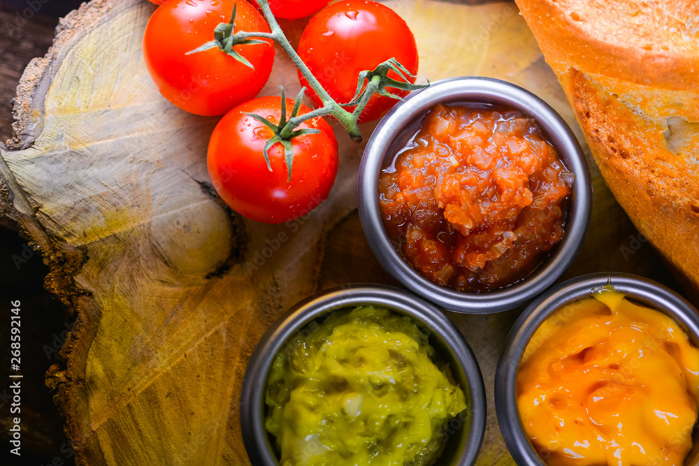 One bunch of fresh tomatoes with various sauces, available on wooden floors One bunch of fresh tomatoes with various sauces, available on wooden floors