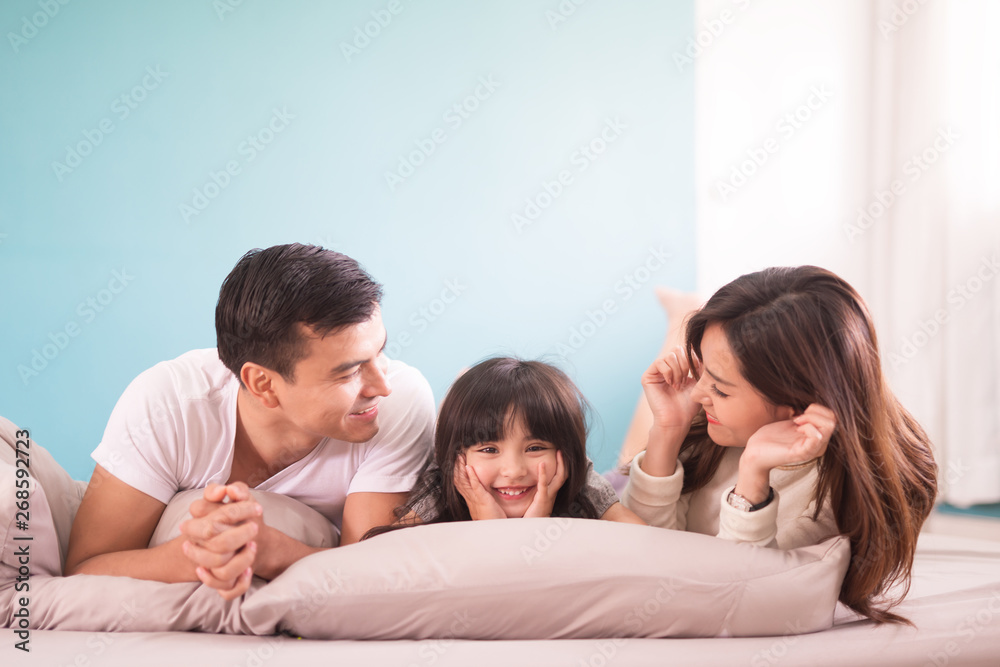 happy asian family spending time together in bedroom. family and home concept