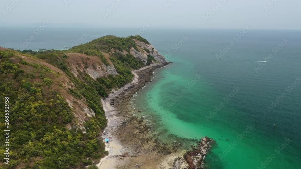 Aerial view of ocean waves, beach and rocky coastline and beautiful forest of Koh Larn, Pattaya, Thailand . Beautiful nature background. Aerial view of ocean waves, beach and rocky coastline and beautiful forest of Koh Larn, Pattaya, Thailand . Beautiful nature background.