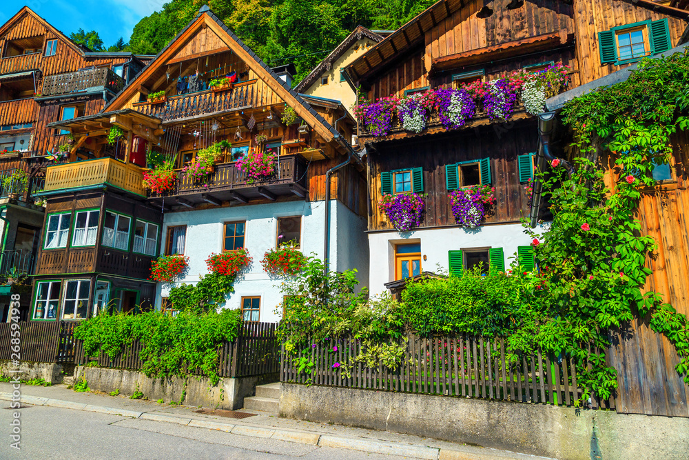Alpine village street with flowery wooden houses, Hallstatt, Salzkammergut, Austria