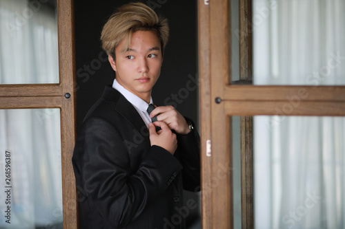 Young Asian businessman in white shirt and tie