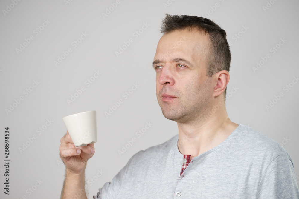 Tired man enjoying his coffee Tired man enjoying his coffee