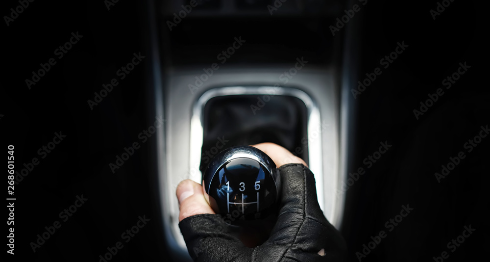 Gear lever. Manual Transmission. Hand on the gear shift in the car