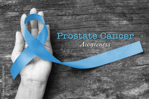 Blue ribbon symbolic of prostate cancer awareness campaign and men's health in November month photo