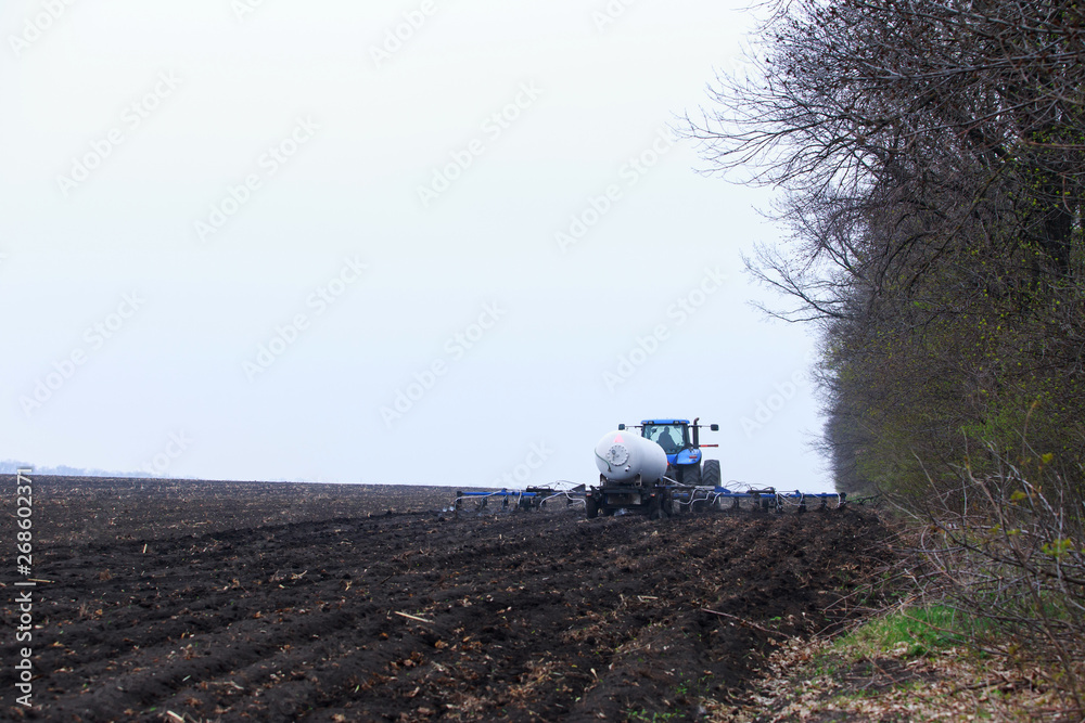 Fototapeta premium Tractor on the field