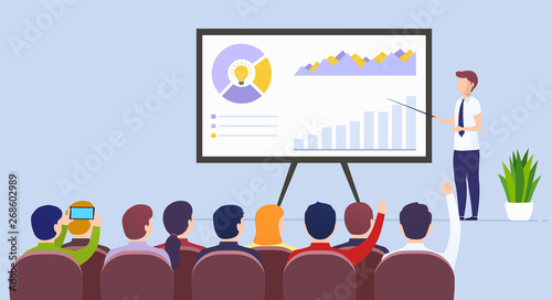 Business man teacher holds a lecture on e-commerce marketing, product development for a seated audience using a whiteboard. Business presentation, motivation for crowd of people.