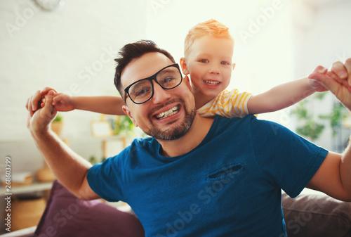 Father's day. Happy family son hugs his dad