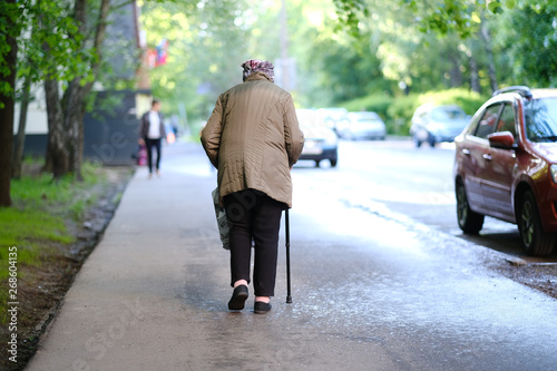 Old hunched women walking on the street