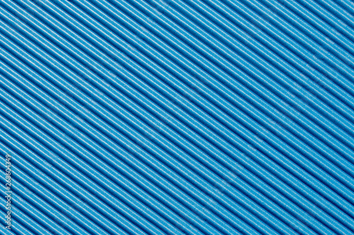 Abstract textured background created with striped details of blue corrugated cardboard