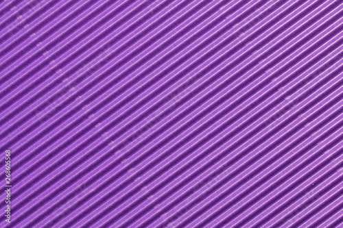 Abstract textured background created with striped details of purple corrugated cardboard