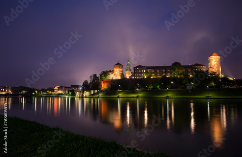 View of the night KRAKOW. The Royal Wawel Castle as seen from another bank of Vistula in Krakow, Poland, Europe