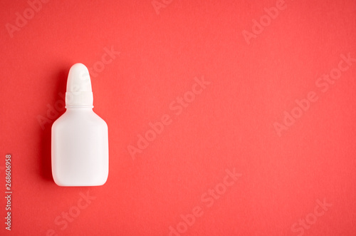 Nasal spray bottle composition, white template bottle on pink background