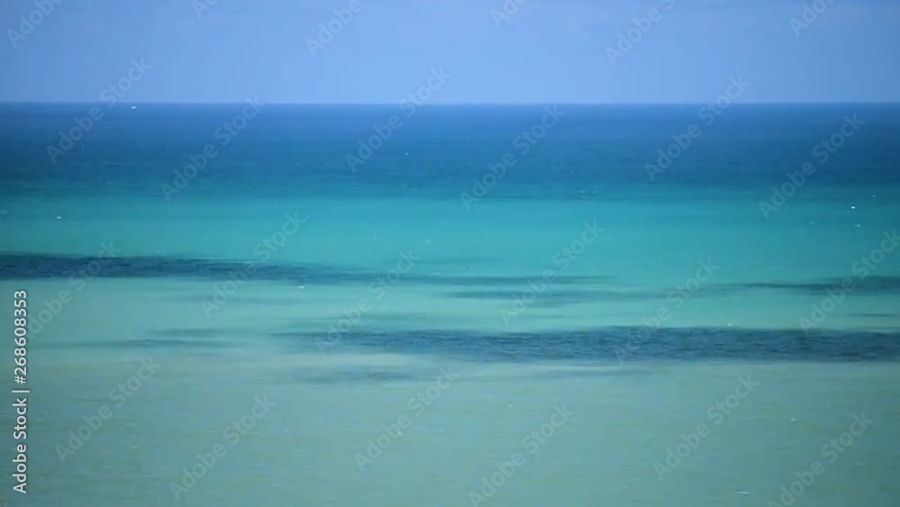 Time-lapse of a beautiful tropical ocean, with dynamic changing colors from clouds casting shadows Time-lapse of a beautiful tropical ocean, with dynamic changing colors from clouds casting shadows