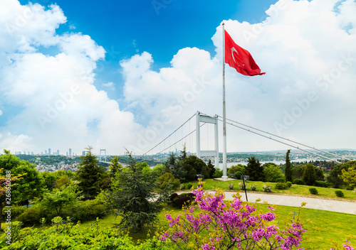 Judas trees (Turkish: Erguvan) in Istanbul. Beautiful spring view of the Istanbul Bosphorus from Otagtepe. Fatih Sultan Mehmet Bridge. Istanbul, Turkey.. photo