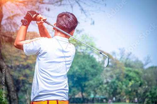 Golfer playing golf in the evening golf course,