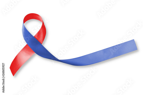 Red and Blue ribbon awareness on woman human hand aged wood for Congenital Heart Defects disease photo