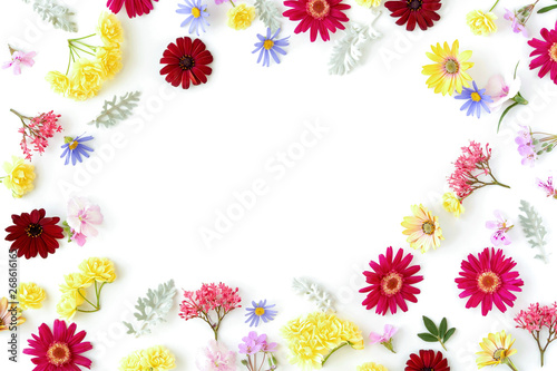 Floral pattern with spring flowers and leaves on white background with copy space. Flat lay. Top view