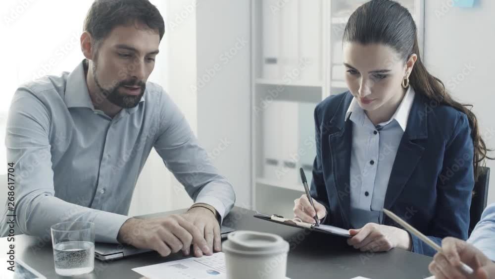 Corporate business team examining financial reports Corporate business team examining financial reports
