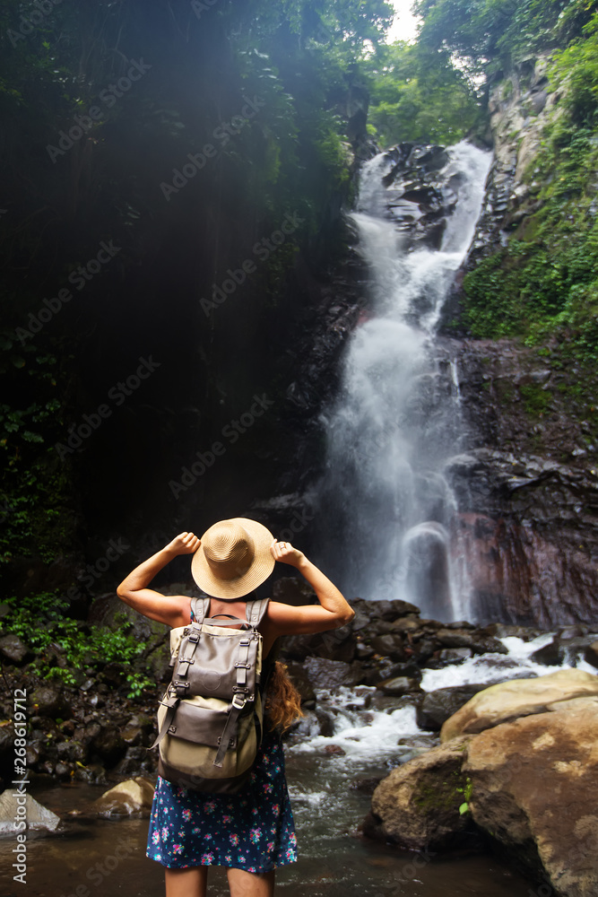 Fototapeta premium Woman near waterfal on Bali, Indonesia