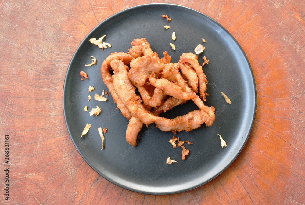 fried slice salty pork with crispy garlic on plate fried slice salty pork with crispy garlic on plate