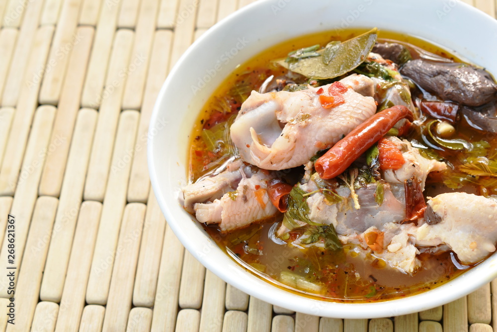boiled chicken bone with herb and tamarind leaf Thai spicy soup on bowl boiled chicken bone with herb and tamarind leaf Thai spicy soup on bowl