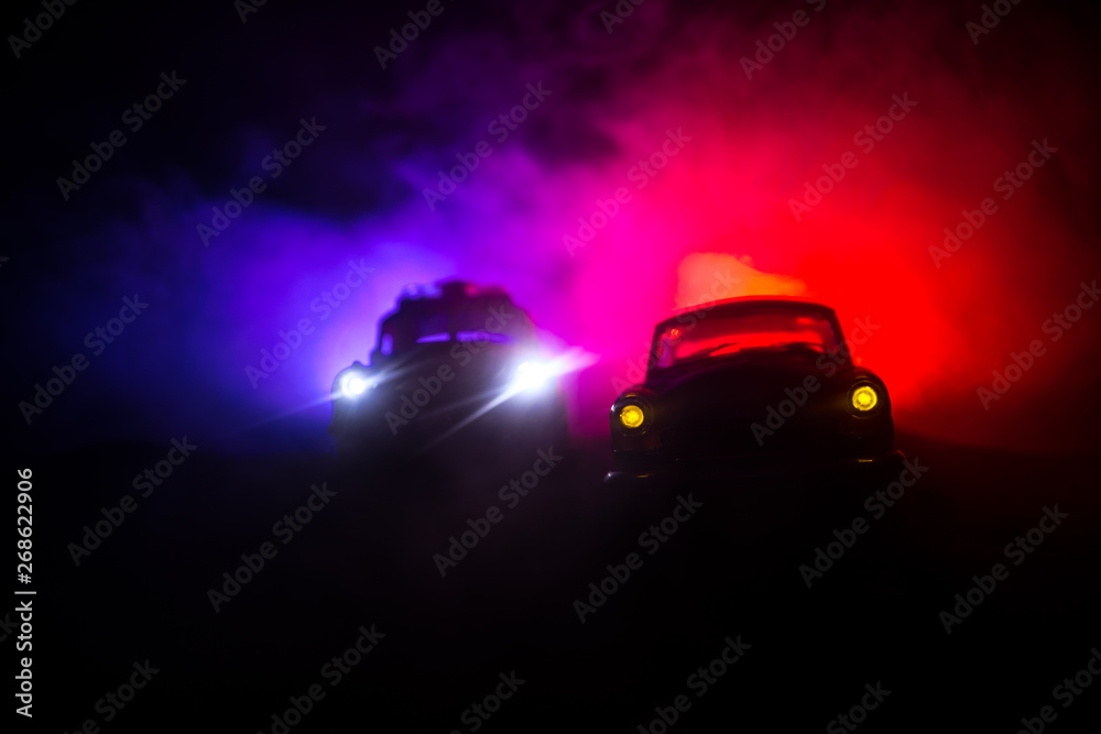 Police car chasing a car at night with fog background. 911 Emergency response police car speeding to scene of crime. Selective focus