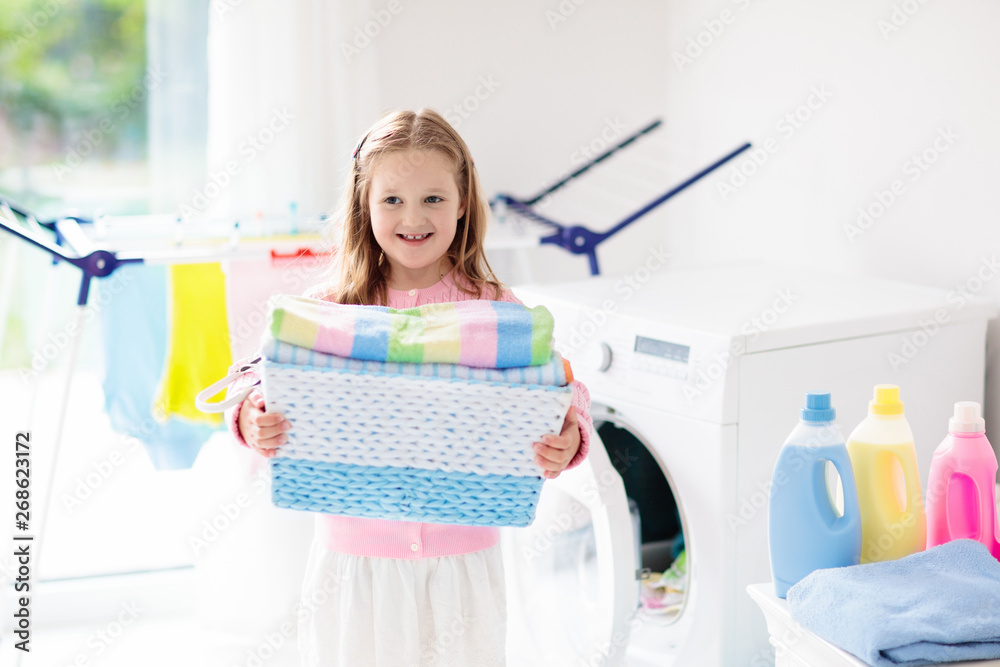 Child in laundry room with washing machine Child in laundry room with washing machine