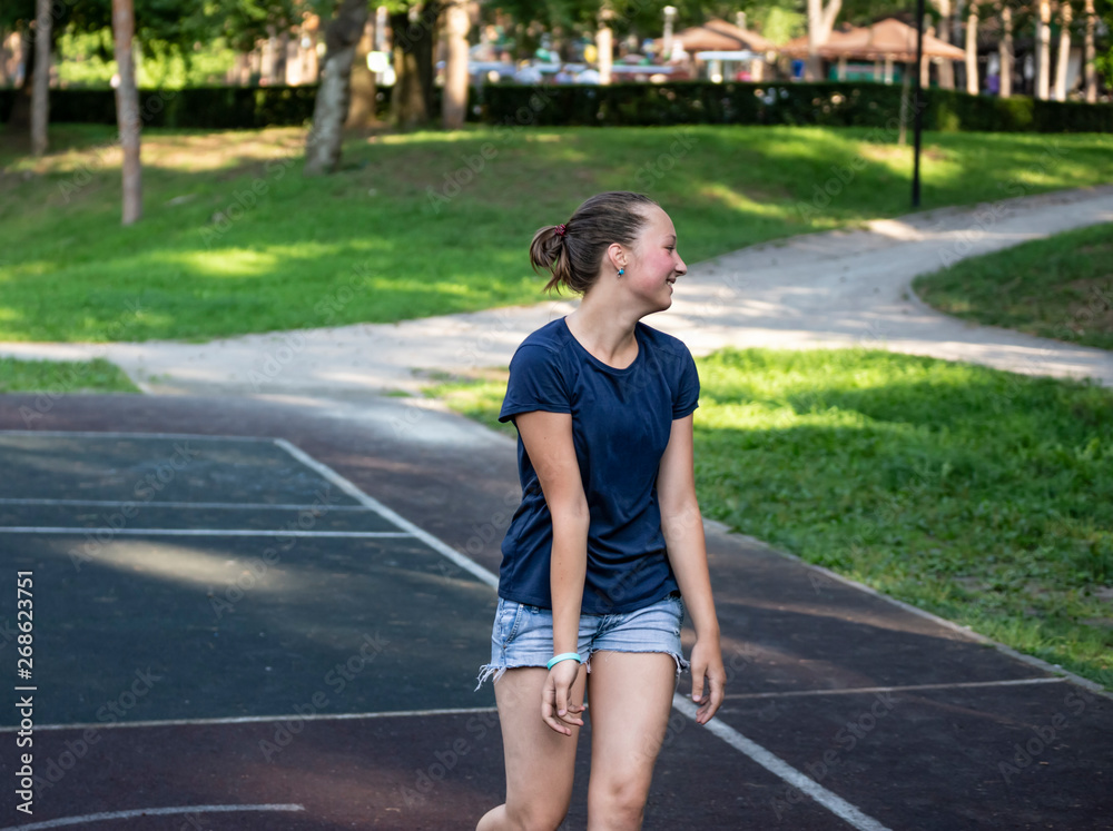 Portrait of teen girl on playground in summer park.