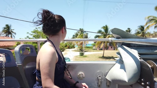 Girl goes on a sightseeing double-Decker bus on Varadero, Cuba photo