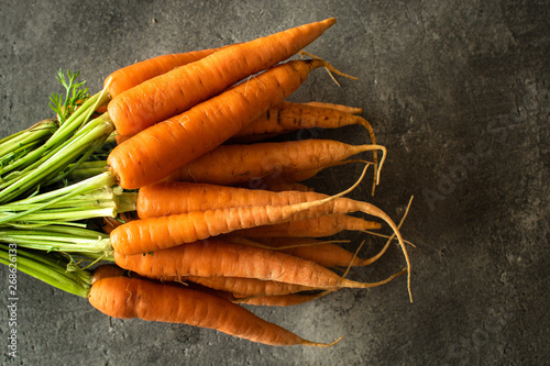Nantes Carrots on Rustic Dark Background. Fresh Organic Superfood Healthy Eating Concept and Diabetes Control.