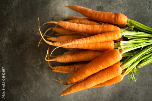 Nantes Carrots on Rustic Dark Background. Fresh Organic Superfood Healthy Eating Concept and Diabetes Control.