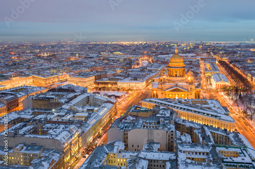 ST. PETERSBURG, RUSSIA - MARCH, 2019: Isaac Cathedral among roofs of buildings, St Petersburg, Russia at night © Stanislav Samoylik