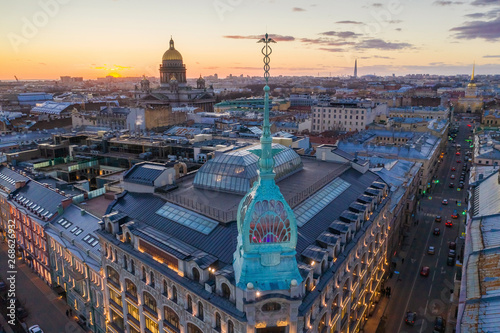 ST. PETERSBURG, RUSSIA - MARCH, 2019: Department store shop class luxury, near the Red Bridge. In the background the city and St. Isaac's Cathedral, in the evening at sunset