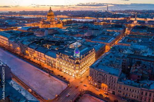 ST. PETERSBURG, RUSSIA - MARCH, 2019: Department store shop class luxury, near the Red Bridge. In the background the city and St. Isaac's Cathedral, in the evening at sunset