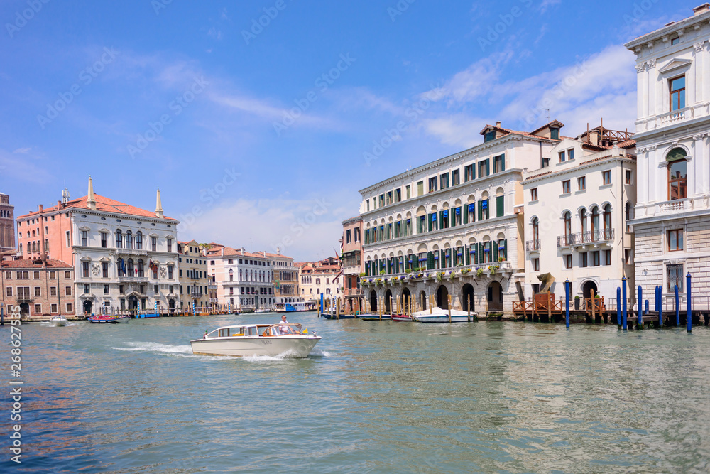 VENICE, ITALY - MAY, 2017: Beautiful view to colorful Venetian architecture located near Ponte di Rialto/ Rialto bridge, water tram stop/station at the Canal Grande