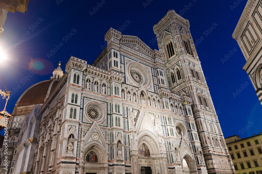 Florence Duomo beautiful marble facade, Cattedrale di Santa Maria del Fiore (Basilica of Saint Mary of the Flower Cathedral) on Piazza del Duomo square in the evening, at night, Tuscany, Italy