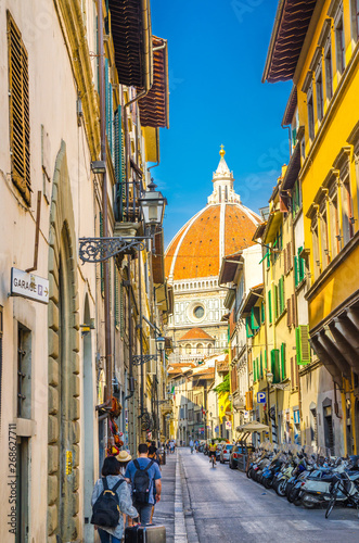 Fototapeta Naklejka Na Ścianę i Meble -  Dome of Florence Duomo, Cattedrale di Santa Maria del Fiore, Basilica of Saint Mary of the Flower Cathedral, view from narrow street in historical city centre, Tuscany, Italy