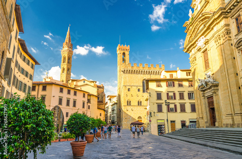 Piazza di San Firenze square with Chiesa San Filippo Neri, Badia Fiorentina Monastero catholic church and Bargello museum in historical centre of Florence city, blue sky white clouds, Tuscany, Italy photo