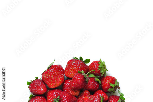 A lot of strawberry berries on a white background. A group of sweet fruits. Vitamin fruits for smoothies, cocktails and preserves. Natural products for healthy nutrition for vegetarians.