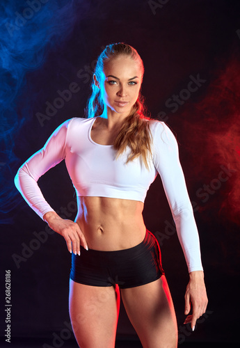 attractive woman with muscular strong legs posing to the camera. close up photo