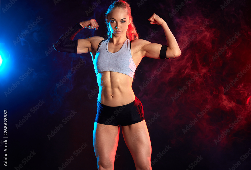 Foto de awesome pleasant strong woman with raised arms showing her  musculars. close up photo. hobby, interest do Stock