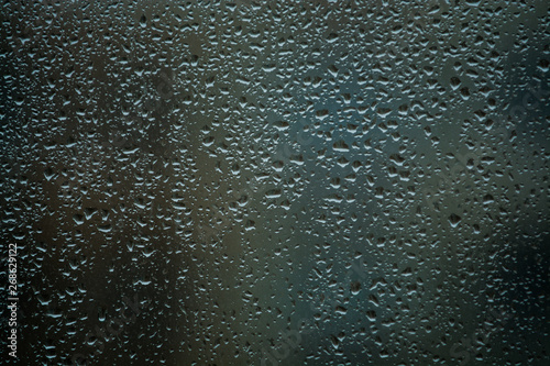 Background or texture. It is a lot of small a rain drops on window glass. Rainy day of spring.