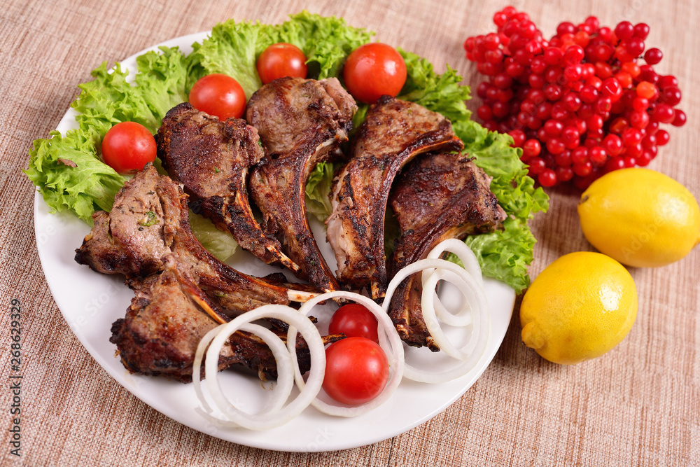 barbecue on a plate with herbs and vegetables. Russian restaurant. The concept of the menu. barbecue on a plate with herbs and vegetables. Russian restaurant. The concept of the menu.